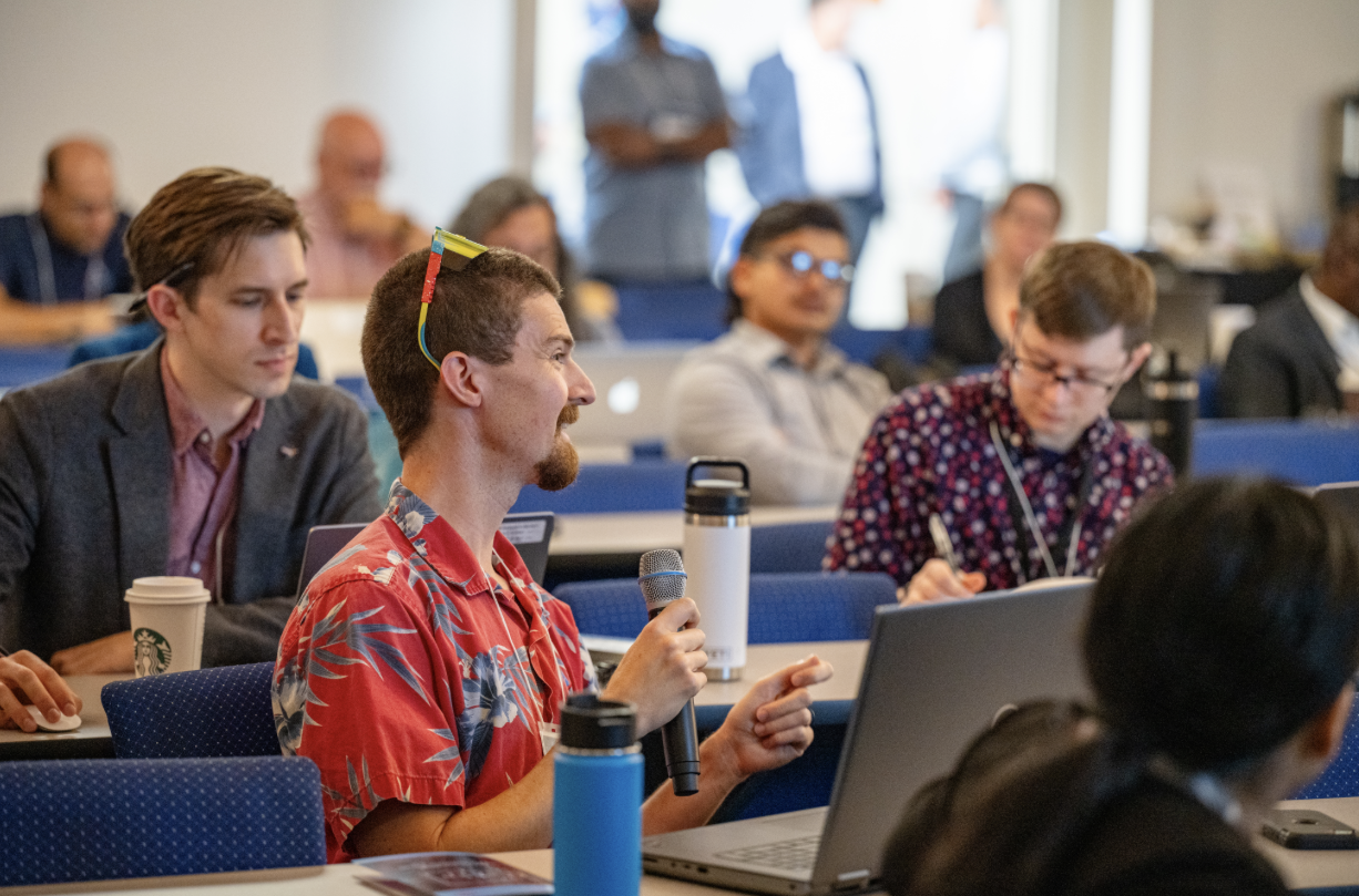 Audience members participate in a discussion during the 2024 NASA SmallSat Learning from Experience, Achievements, and Resolution, Navigation LEARN forum in the ballroom of Building 3 at NASA Research Park.